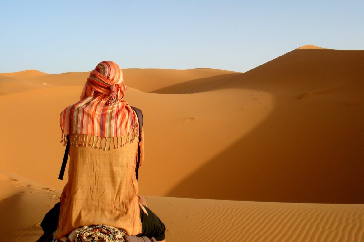 person camel riding on desert