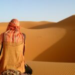 person camel riding on desert